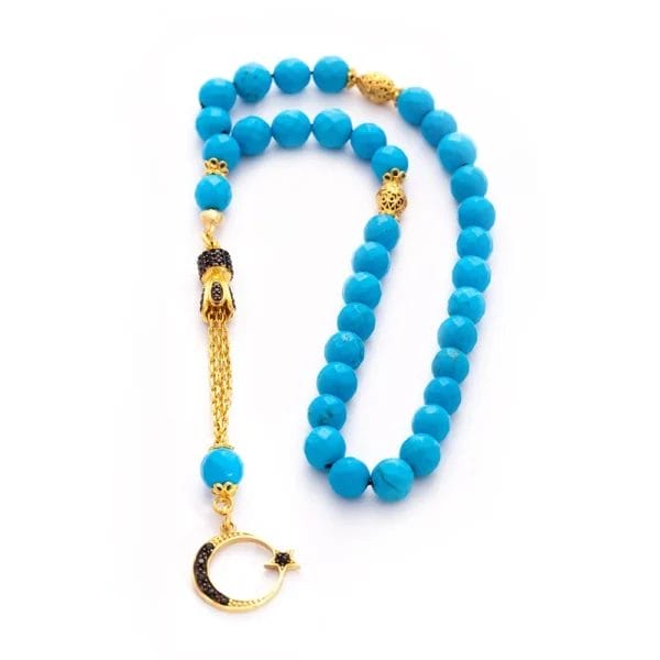 سبحة من حجر الفيروز مطلية بالذهب ومزينة بشرابة من الزركون